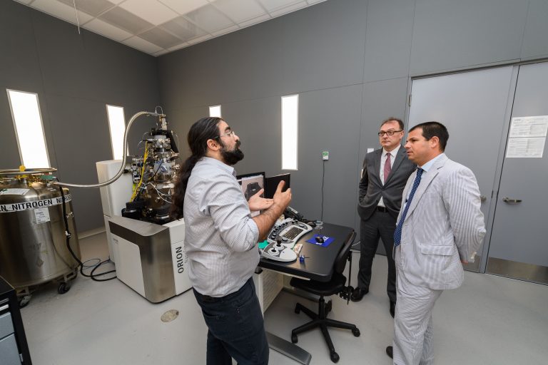 three faculty members discussing research